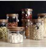 ⁦طقم برطمانات زجاجي 3 قطع احجام مختلفة بغطاء خشبي محكم الغلق لحفظ وتخزين الشاي والسكر والحبوب والبقوليات⁩ - الصورة ⁦2⁩