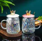 ⁦مج زجاج متعرج 450 ملي بغطاء تاج ومعلقة استانليس ستيل جولد للمشروبات الباردة والساخنة بيد⁩ - الصورة ⁦4⁩